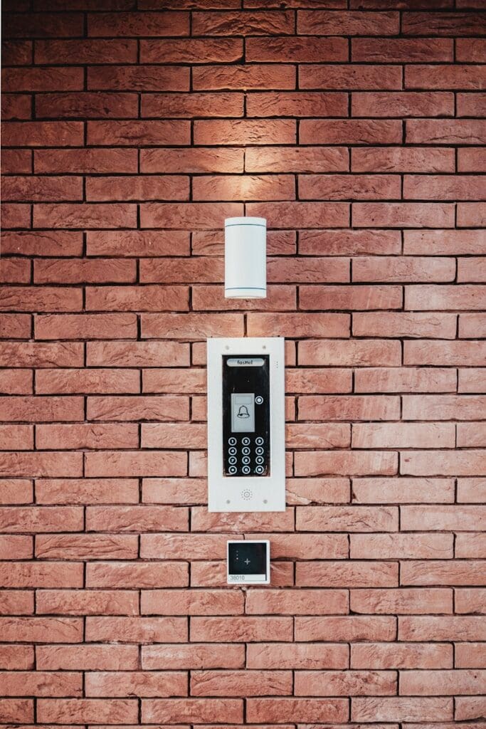 access control multi tenant building intercom black and white wall sconce